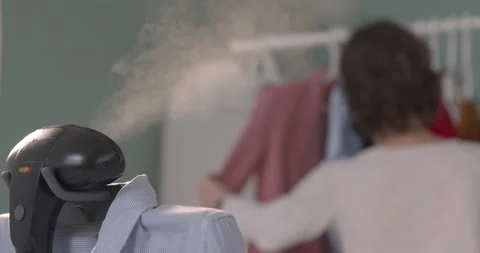 Using steam system for ironing clothes Stock Footage 131842561