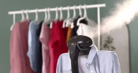 Using steam system for ironing clothes7 Stock Footage 131845629