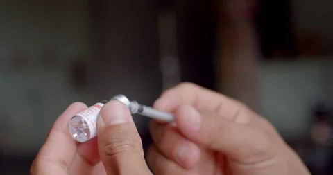 Using syringe suck out of bottle by turning the medicine bottle upside down. Stock Footage 250075220