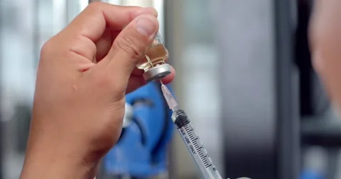 Using syringe suck out of bottle by turning the medicine bottle upside down. Stock Footage 251033985