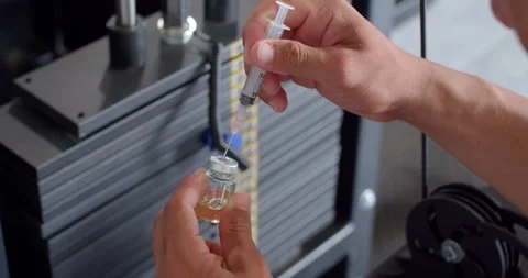 Using syringe suck out of bottle by turning the medicine bottle upside down. Stock Footage 252248970