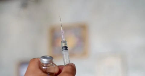 Using syringe suck out of bottle by turning the medicine bottle upside down. Stock Footage 252272342