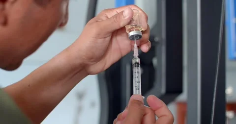 Using syringe suck out of bottle. Stock Footage 277846479