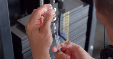 Using syringe suck out of bottle. Stock Footage 277846932