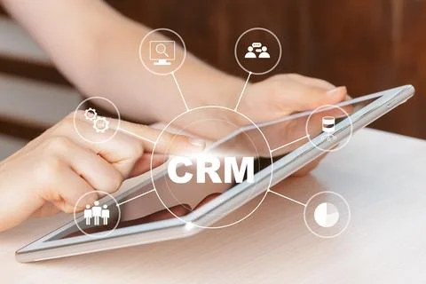 Using a tablet to access CRM tools for managing customer data and interactions Stock Photos