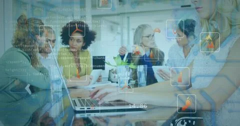 Using tablet and laptops team wearing casual wear analyzing code overlays in 写真素材