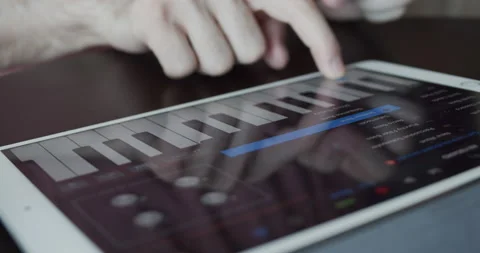 Using tablet app to play digital synthesizer at home Stock Footage 131628770