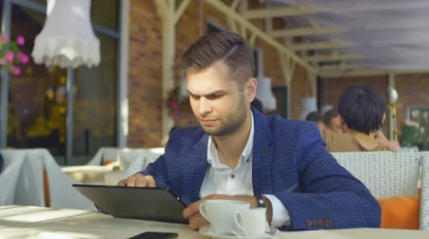 Using the Tablet in Cafe Stock Footage 68927202