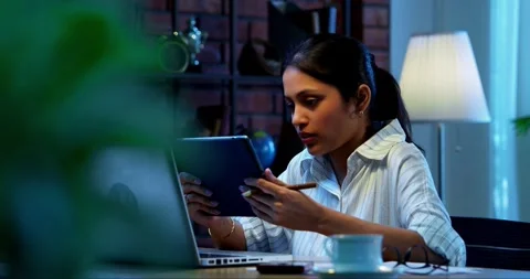 Using tablet computer at work, Indian businesswoman focuses on office task Stock Footage 342573821