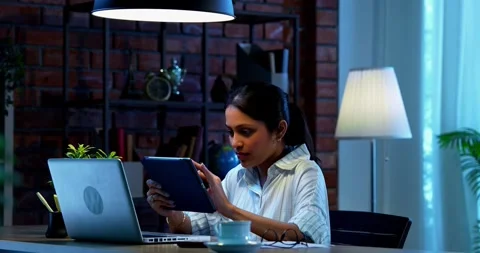 Using tablet computer at work, Indian businesswoman focuses on office task Video stock 342573825
