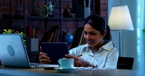 Using tablet computer at work, Indian businesswoman focuses on office task Video stock 342573826