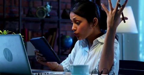 Using tablet computer at work, Indian businesswoman focuses on office task Stock Footage 342573827
