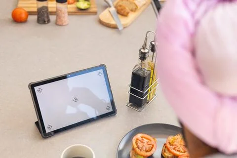 Using tablet for cooking recipe, man preparing meal in kitchen, copy space 스톡 사진
