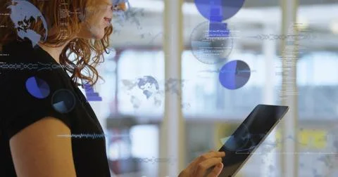 Using tablet, female tech in black top interacting with data overlays in office, Foto stock