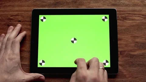 Using Tablet with Green Screen on Wooden Table. Shot in 4K, UHD Stock Footage 74308243