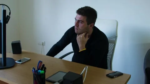 Using Tablet on his Workdesk Stock Footage 68144302