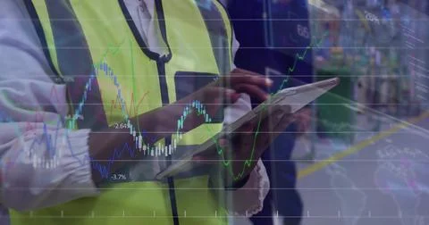 Using tablet, lead wearing hi-vis vest and lanyard tapping screen at plant line, Stockfoto's