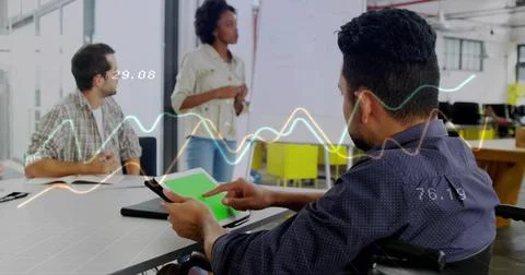 Using tablet, man in patterned shirt tapping in office, showing green-screen and Stock Photos
