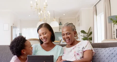 Using tablet, multi-generational african american family sitting on couch, Video stock 298136985