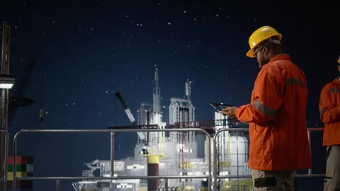 Using tablet, oil crisis geopolitical conflict and drilling rig engineers Stock Footage 336197726