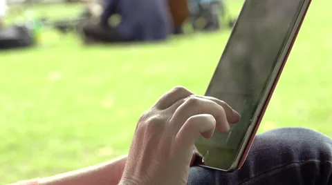 Using tablet in the park Stock Footage 54079815