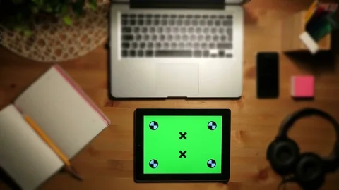 Using Tablet PC with a Green Screen on a Workplace . Aerial View Stock Footage
