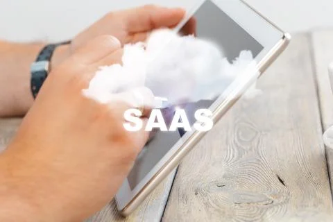 Using tablet for SaaS business solution in modern workspace setting Stock Photos