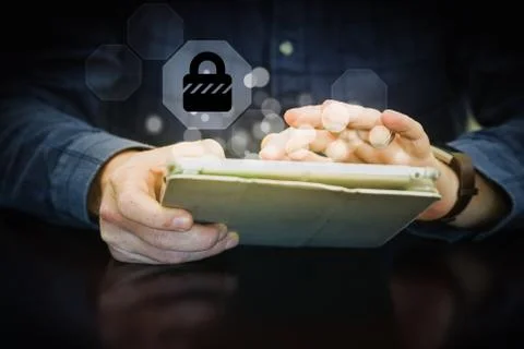 Using a tablet - tablet security with sparks coming from the screen Stock Photos