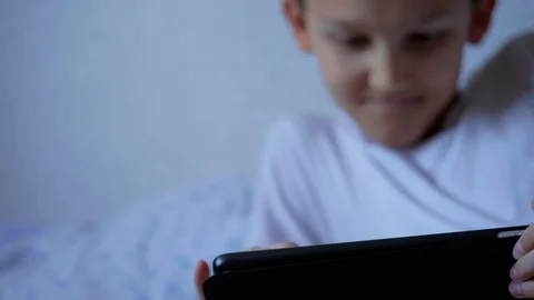 Using tablet teenager boy, focus on device and on face, home Stock Footage 108148531