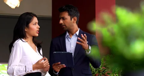 Using tablet while chasing deadline, Indian business colleagues discuss project Video stock 342593727