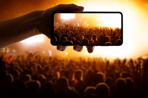 Using technology at the event. Mobile phone in hand Stock Photos