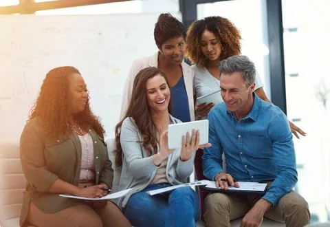Using technology to make their meetings more efficient. a creative team using a Stock Photos