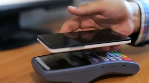 Using a terminal and a phone in a restaurant man Stock Footage 93686680