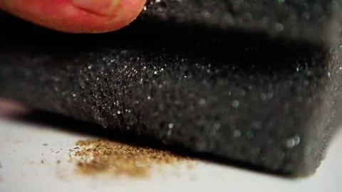 Using textured pad to wipe counter, removing pepper stains from white kitchen Stock Footage 321611729