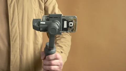 Using three-axis electronic stabilizer to make vlogs or video shooting Stock Footage 243100436