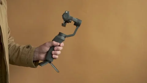 Using three-axis electronic stabilizer to make vlogs or video shooting. Stock Footage 246707968