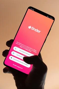 Using tinder app on smartphone Stock Photos