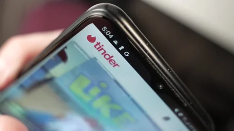 Using Tinder Dating App On a Smartphone Closeup Screen 스톡 동영상 270817568