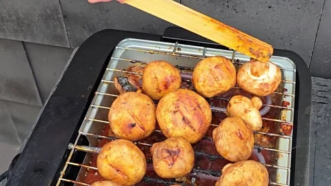 Using Tongs to Flip White Mushrooms on Barbecue Grill Stock Footage 344703928