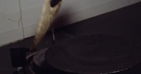 Using tongs to make chapati Stock Footage 133005128