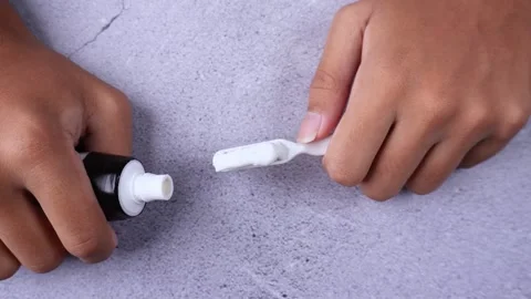 Using toothpaste onto brush Stock Footage 275872435