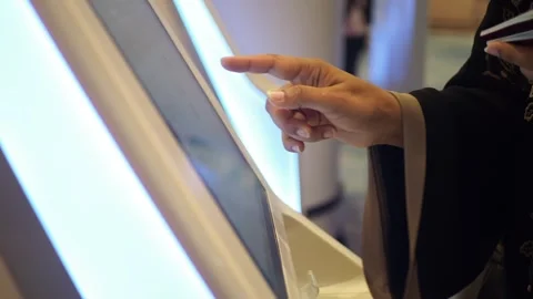 Using a touchscreen display at a kiosk in a airport Stock Footage 330275745