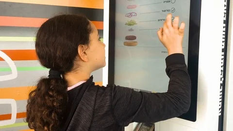 Using touchscreen of food order kiosk Stock Footage 91546571