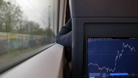 Using trading view app on MacBook laptop in the train. Stock Footage 186839291