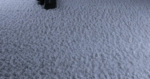 Using vacuum cleaner cleaning white carpet in living room Stock Footage 129962957