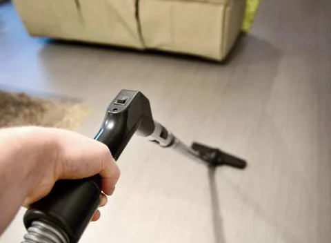 Using vacuum cleaner in home. Fotos Stock
