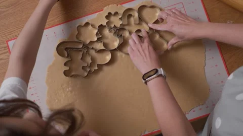 Using various metal cookie cutters to cut shapes from gingerbread dough. Stock Footage 311807032