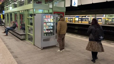 Using a vending machinet Dutch railway station Weesp Stock Footage 318411348