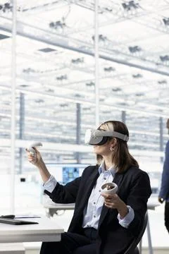 Using VR gear, semiconductors and female hardware developer in RD office Stock Photos
