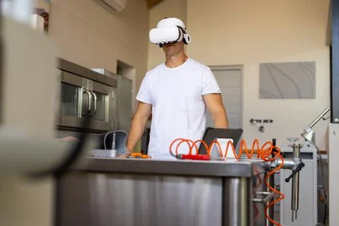Using VR headset, man working in prosthetic lab with tools on table Stock Photos